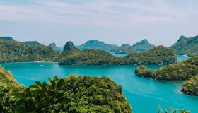 Crystal waters and limestone cliffs in Ang Thong for an Ang Thong Tours banner with Legend Travel Group.